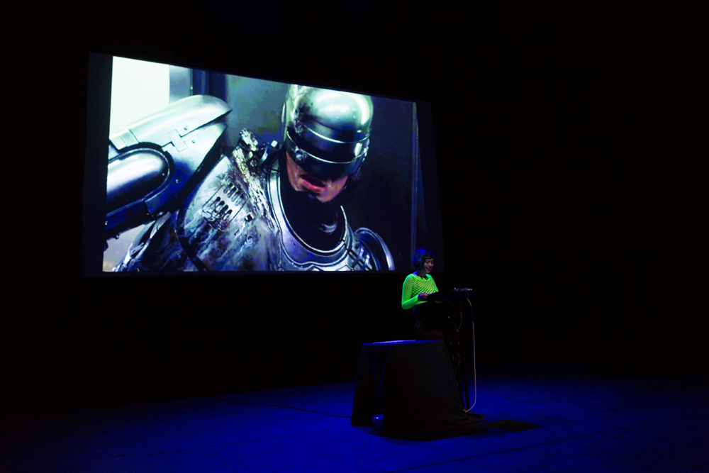 Robocop off to one side on a screen behind Jackie Wang 