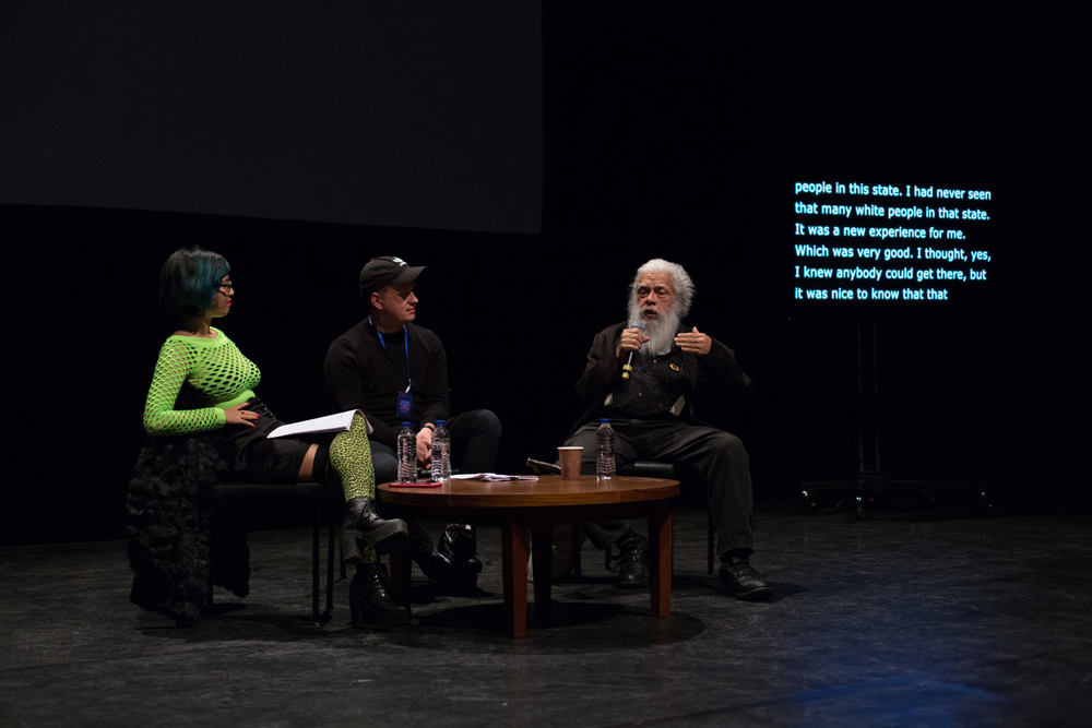 Jackie Wang, Huw Lemmey, Samuel Delany sitting around a table talking 
