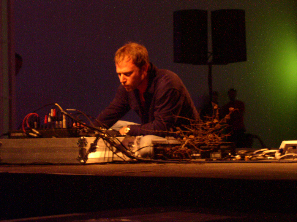 Steve Roden next to a mixer and musical equipment