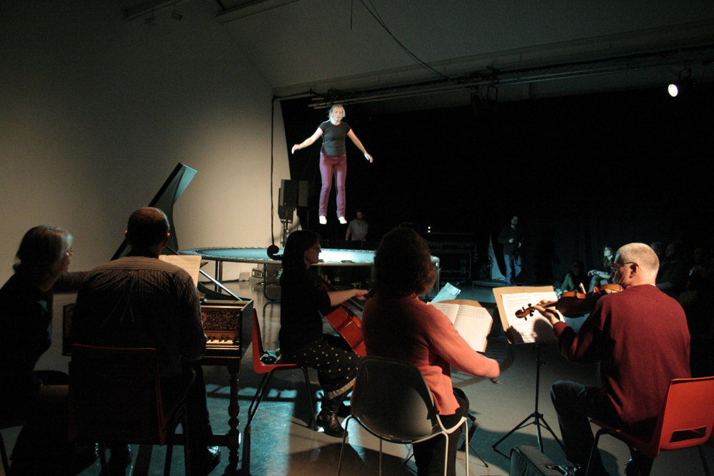 Aileen Campbell on a trampoline singing Vivaldi accompanied by musicians