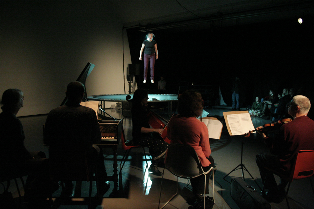 Aileen Campbell on a trampoline singing Vivaldi accompanied by musicians