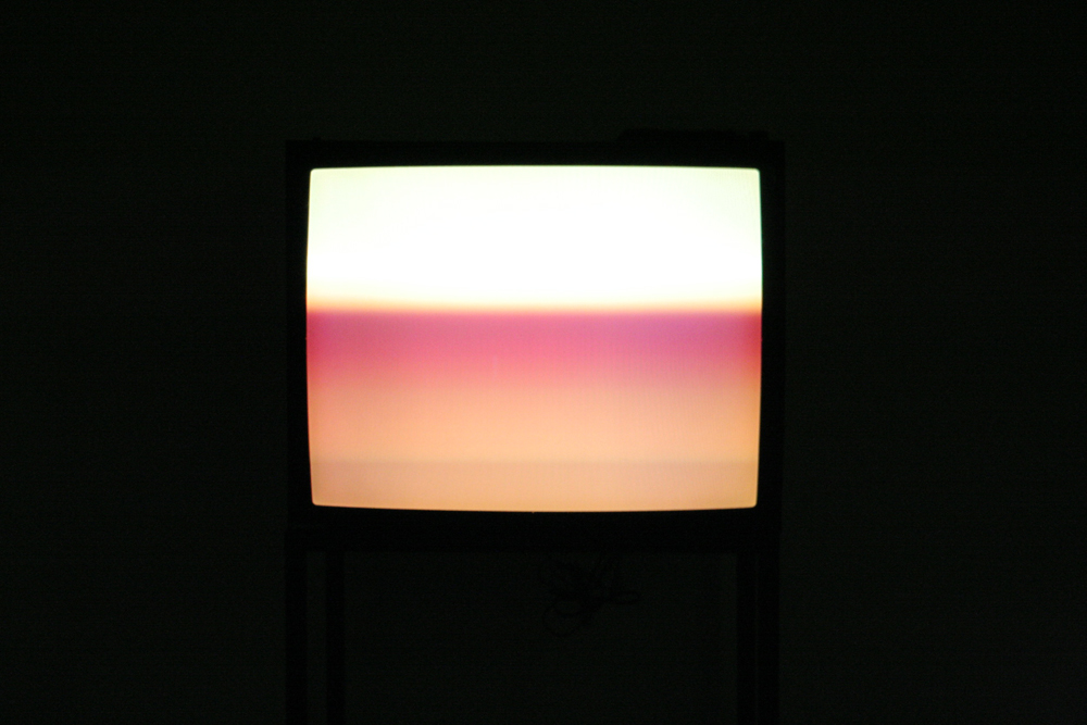 A cathode ray tube television showing bands of pink light