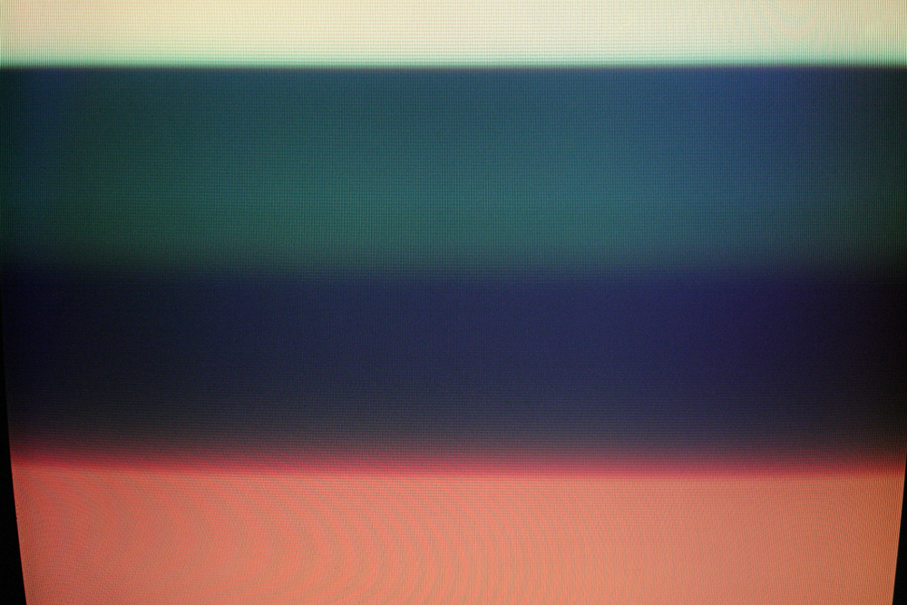 Close up of a cathode ray television showing bands of colour