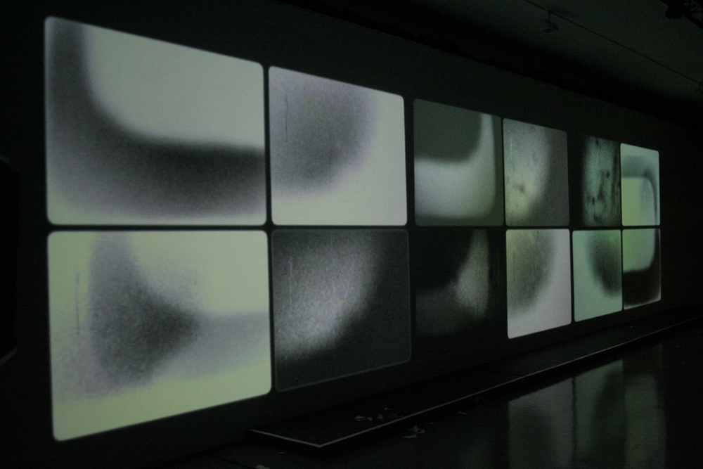 twelve rectangular images projected on a long screen