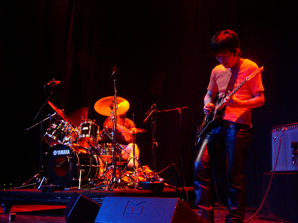 Kyoaku No Intention on stage playing drums and guitar at MLFC 05