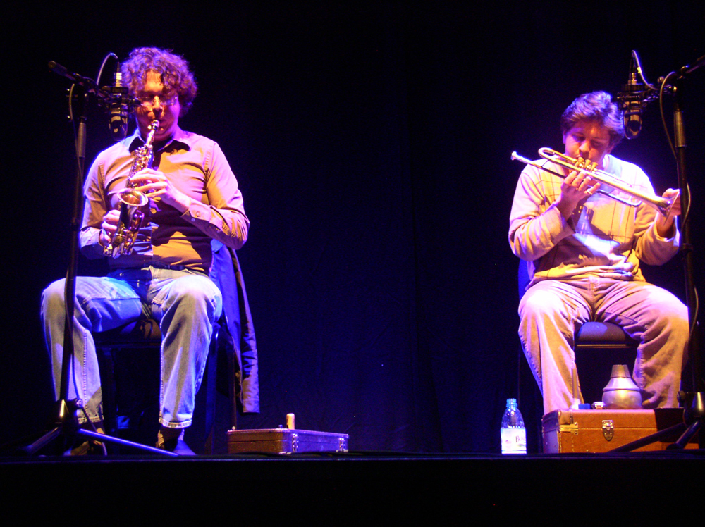 Bhob Rainey and Greg Kelly playing saxophone and trumpet