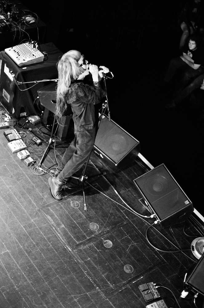 Keiji Haino singing into a microphone on stage at MLFC 05