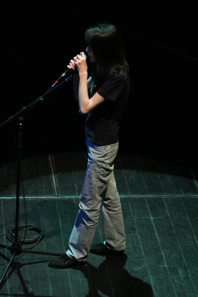 Junko singing into a microphone 