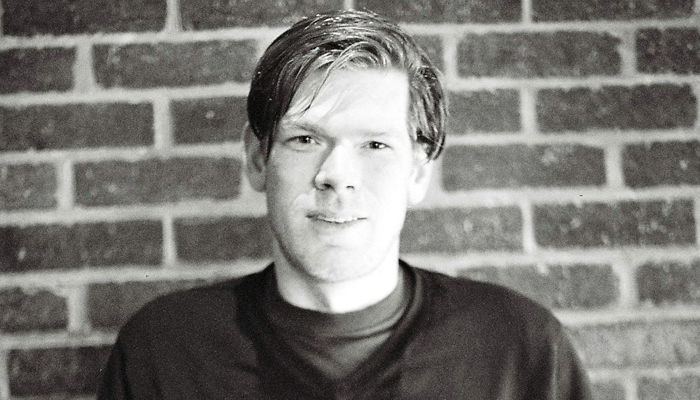 Joe Colley portrait against a brick wall