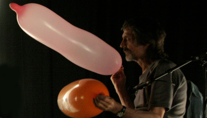 Terry Day holding balloons in performance with Rhodri Davies at MLFC 07