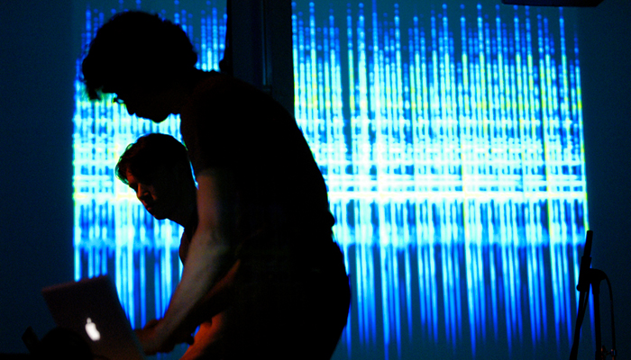 The user performing in front of a projection of digital images