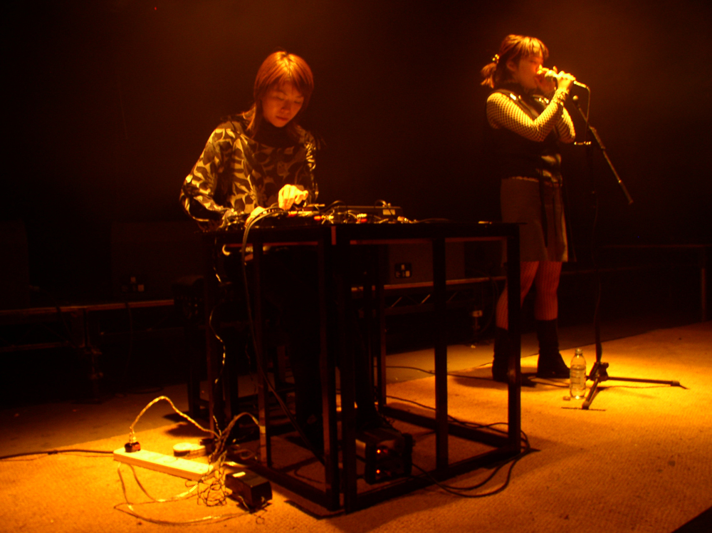 Sachiko M & Ami Yoshida performing in yellow light at INSTAL 03