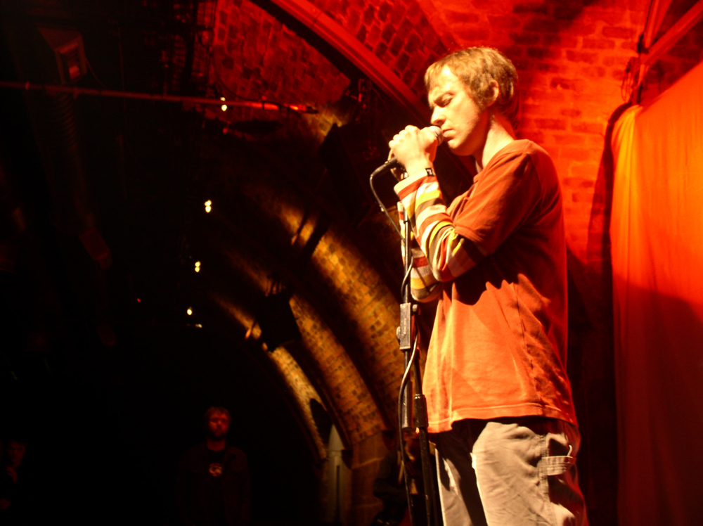 Richard Youngs standing with a microphone at INSTAL 04