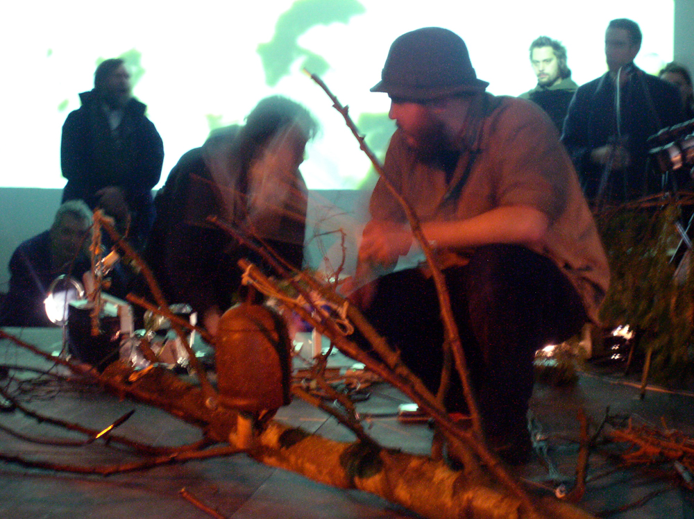 Thuja & Keith Evans on stage at KYTN among branches and projections