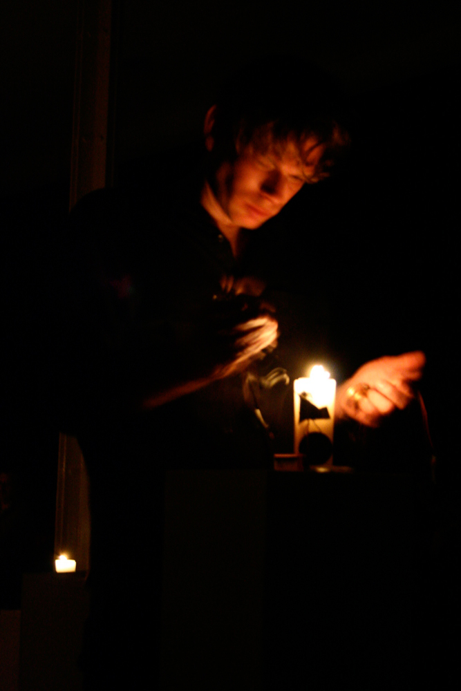 Close up of Joe Colley holding a diode near a candle