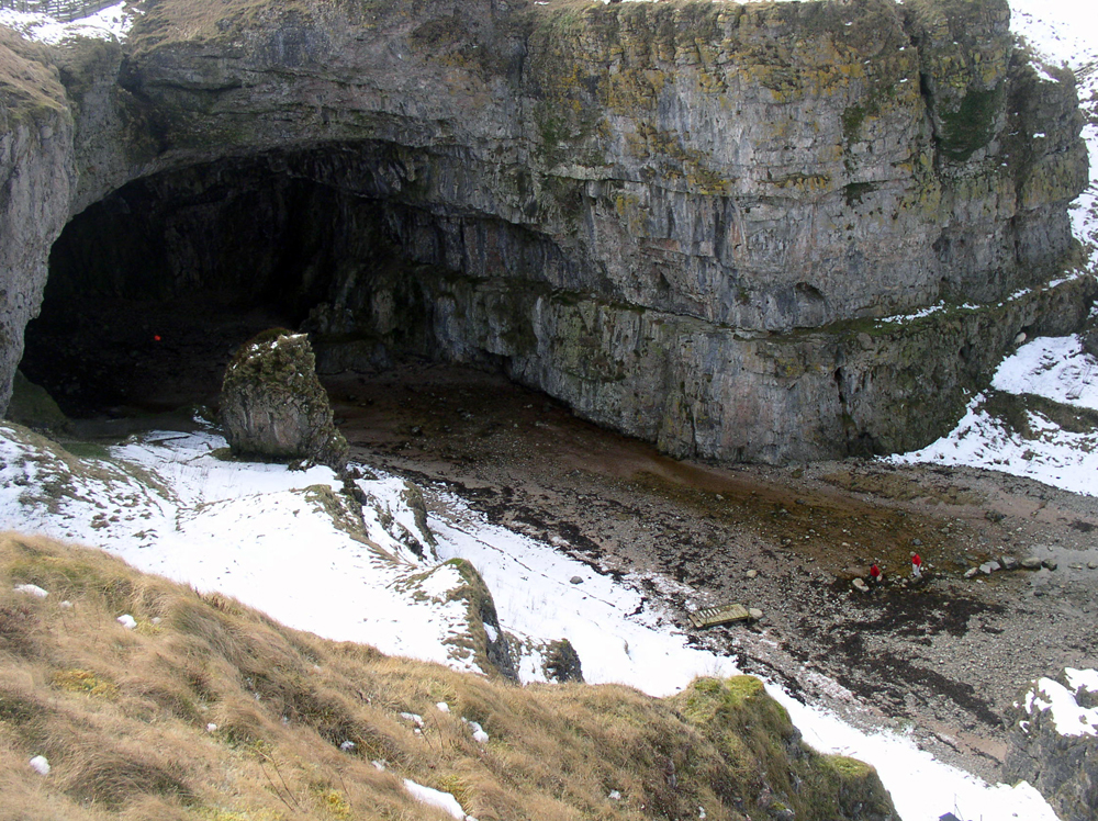 Exterior shot of Smoo Cave in winter large gaping dark hole in a beach