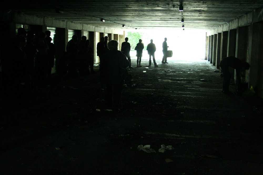 An underpass in Cumbernauld with an audience, light at one end