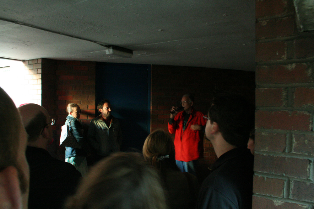 Denis Wood talking to an audience in a low ceiling space