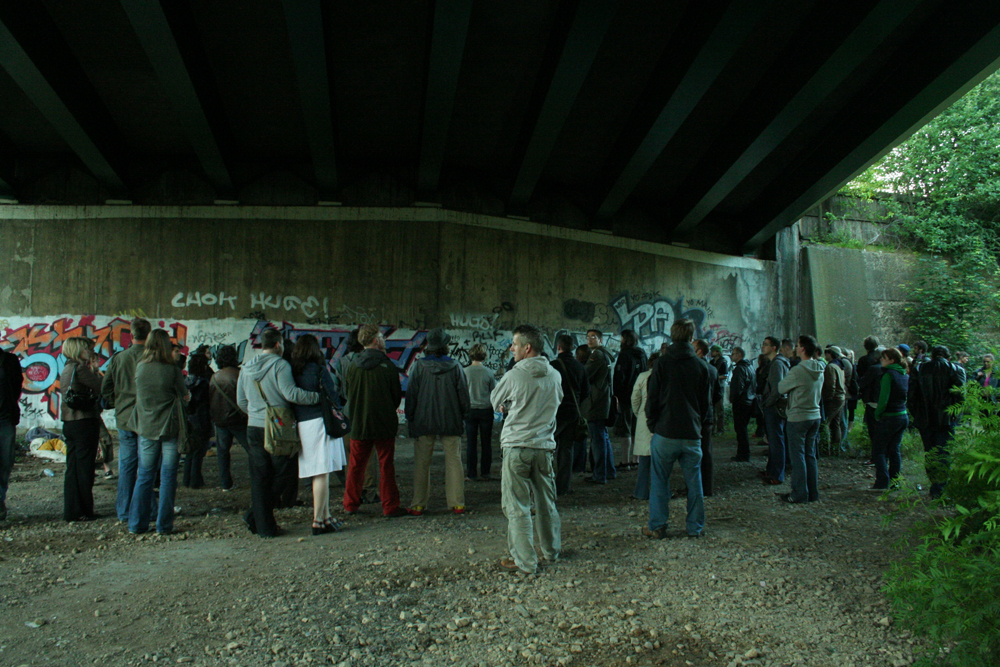 An audience under a bridge somewhere in newcastle