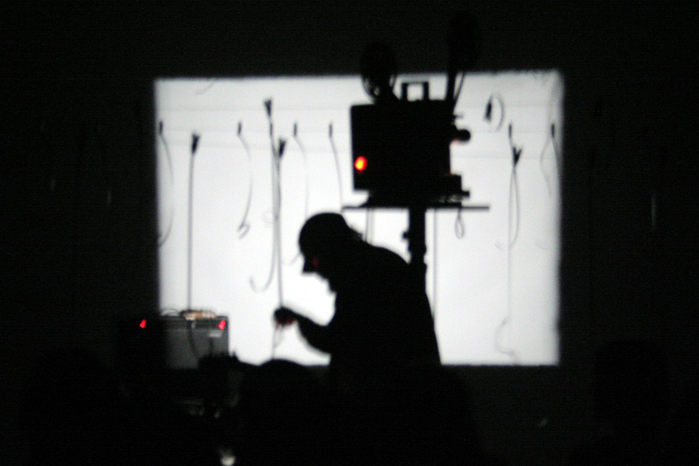 Andrew in silhouette in front of a projection