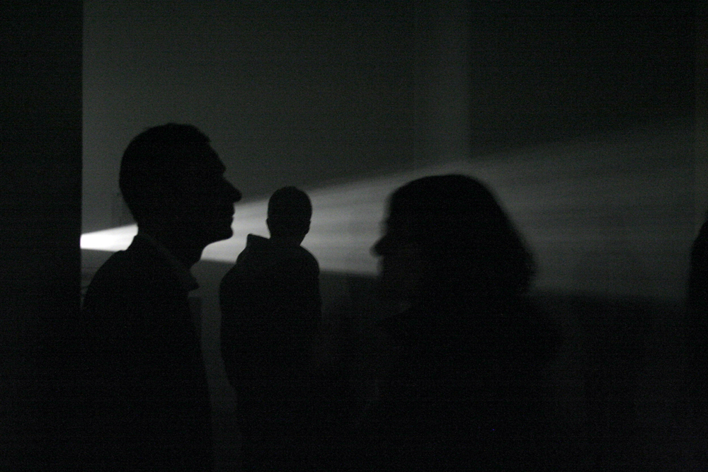 Heads of audience members silhouetted