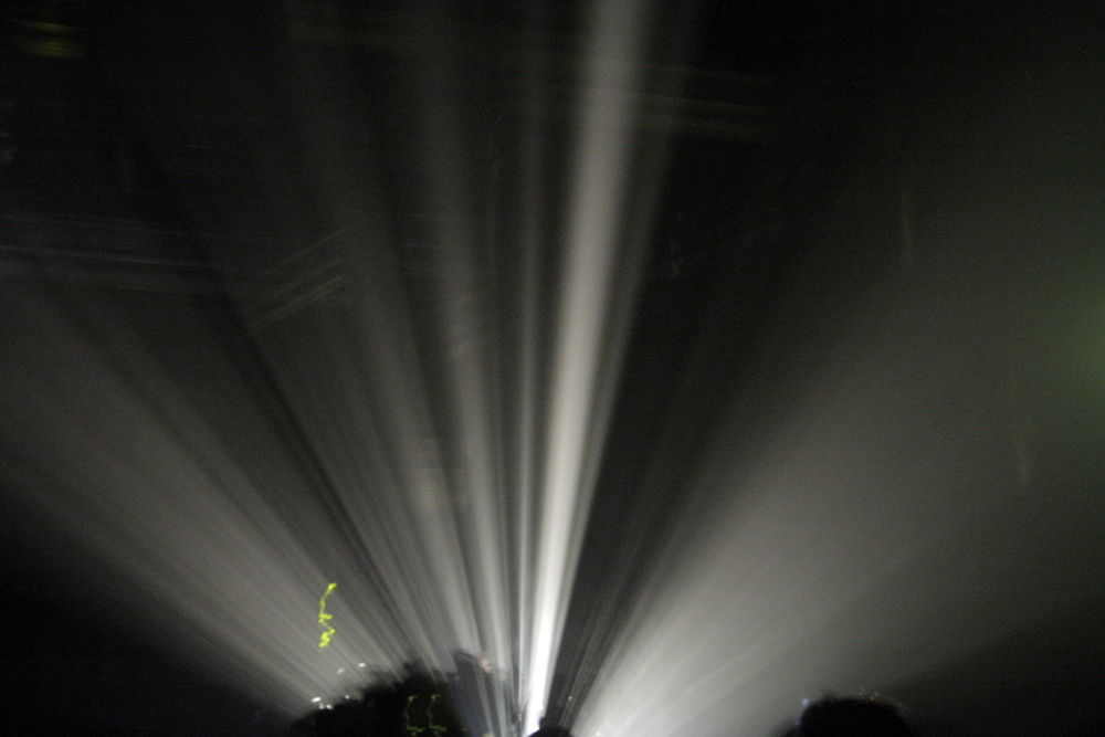 Beams of light fanning out over an audience