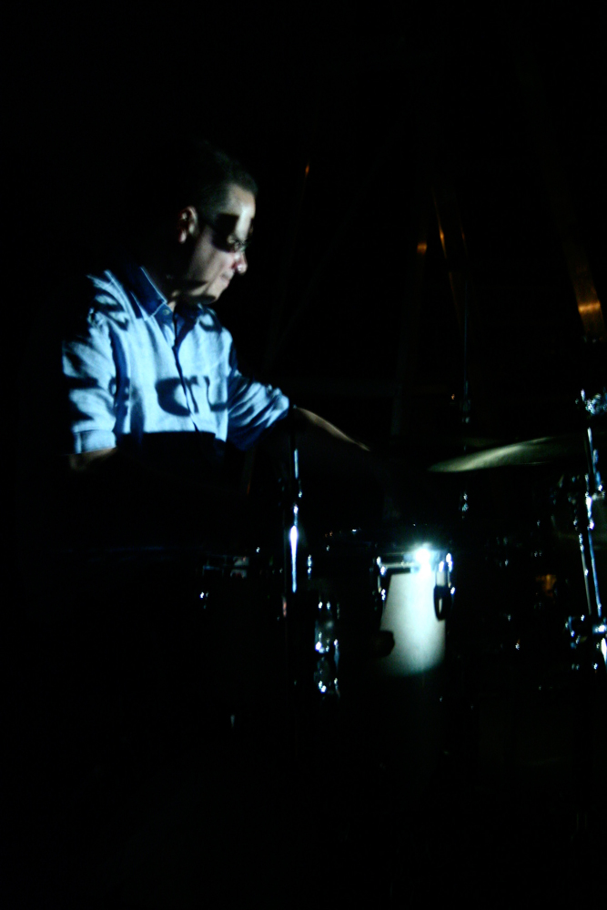 Mark Saunders playing drums in the dark