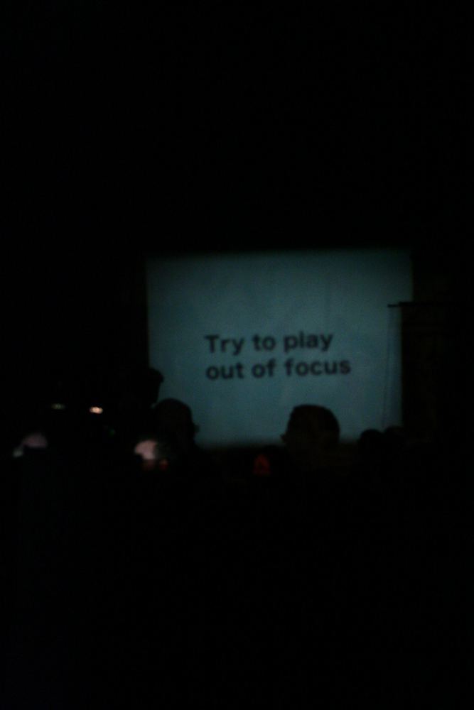 'Try to play out of focus' projected on a wall