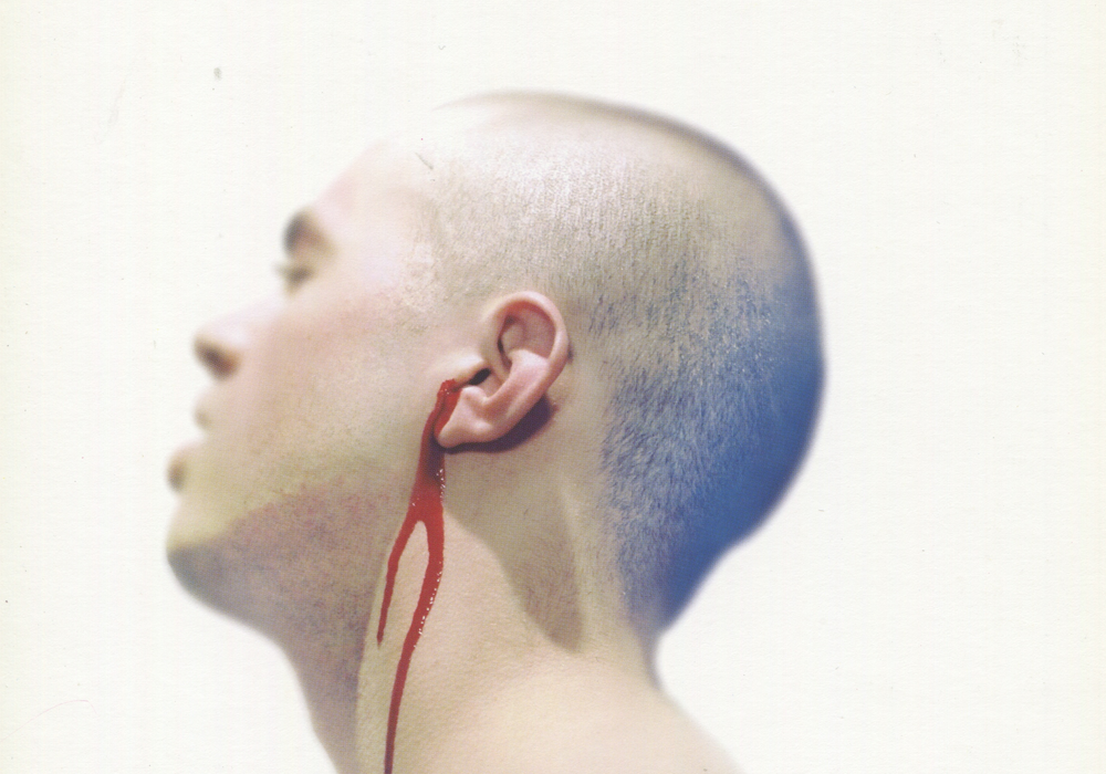 Publicity image of a man with blood coming from his ear