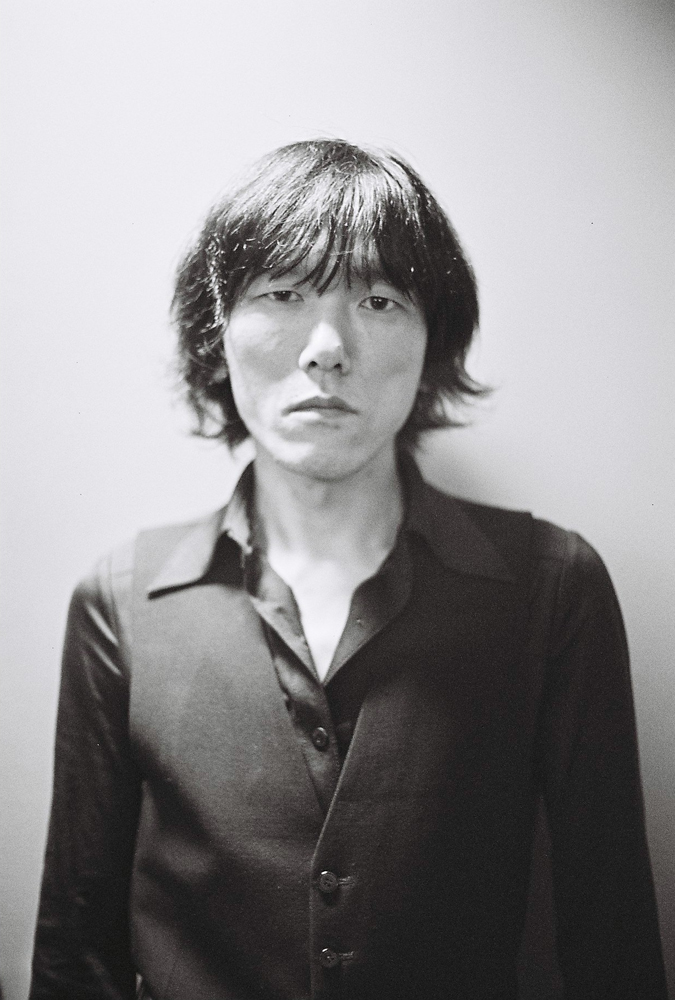 Kiyoharu Kuwayama standing backstage at INSTAL 06
