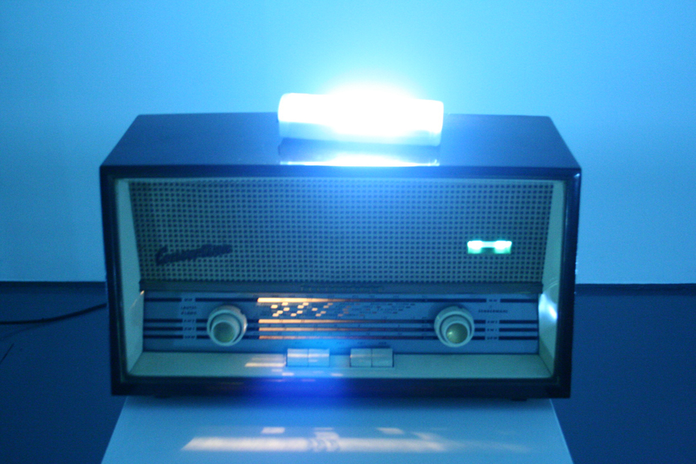An old radio with a fluorescent light on top