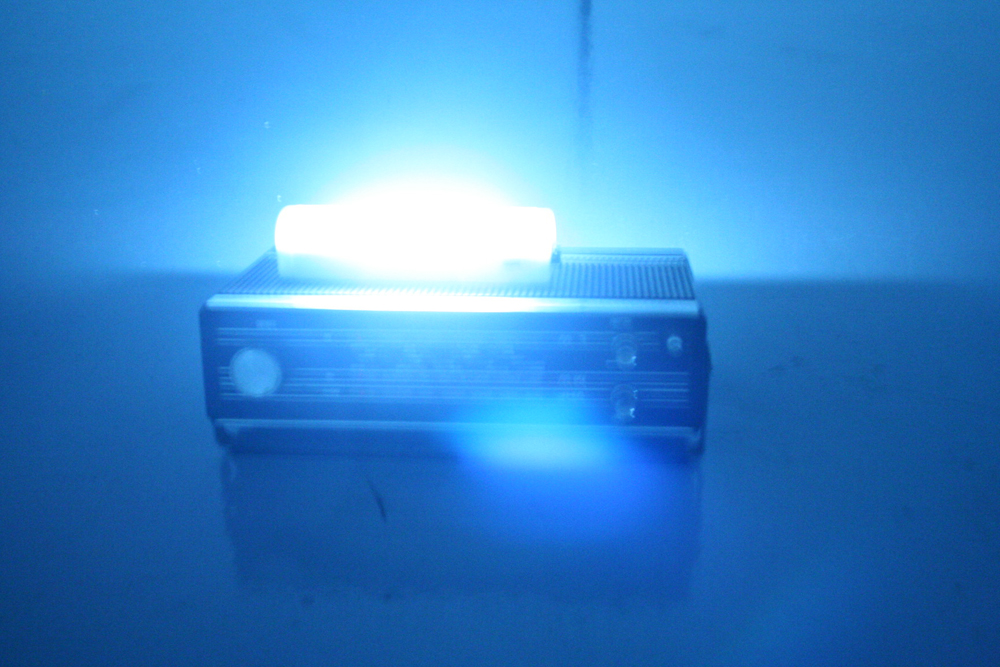 Fuzzy image of an old radio with a fluorescent light on top