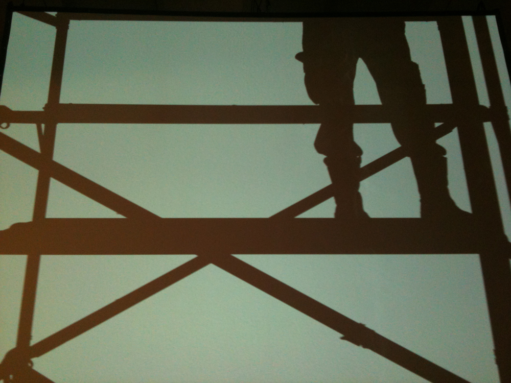 An image of someone's legs and a platform in silhouette 