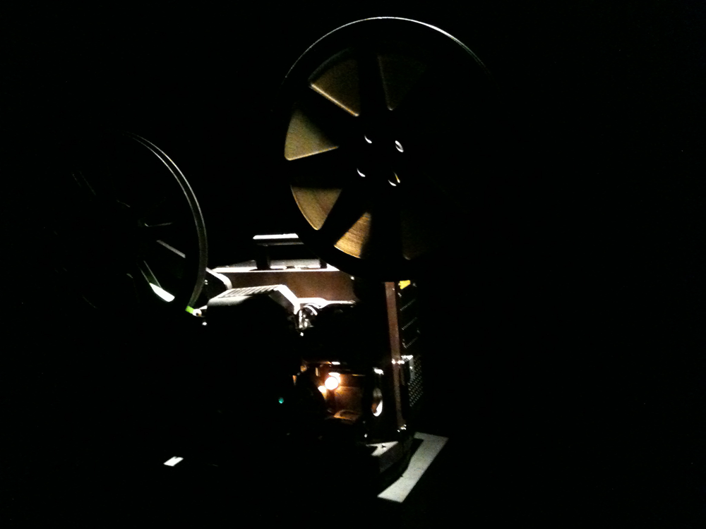 A projector running in a dark room 
