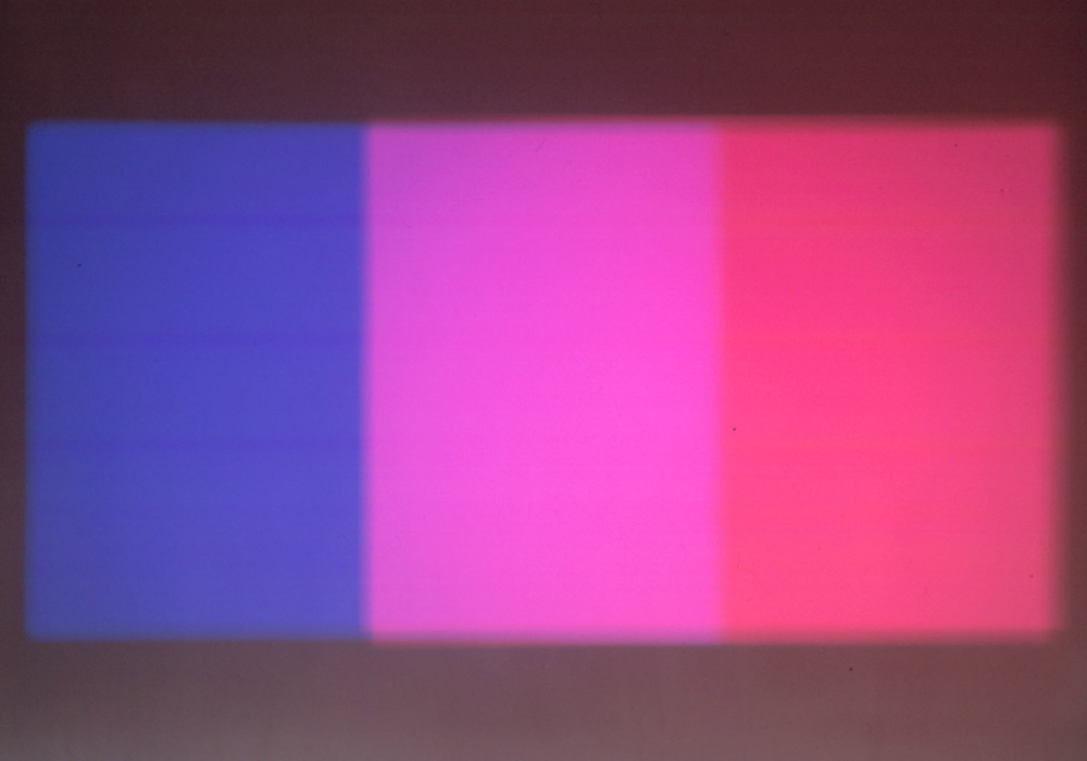 Paul Sharits' Shutter Interface projected on a wall: three bands of colour