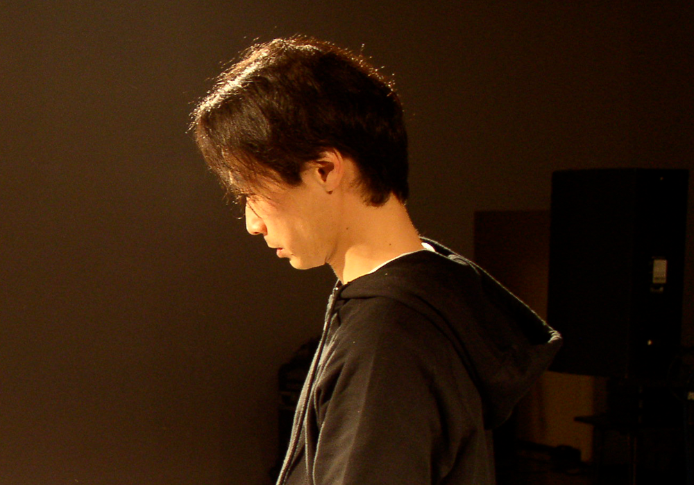 Ryoji Ikeda pictured against a dark background