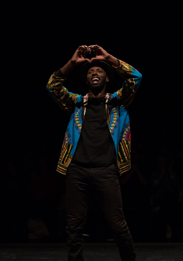 Storyboard P making a heart shape with his hands during a dance performance