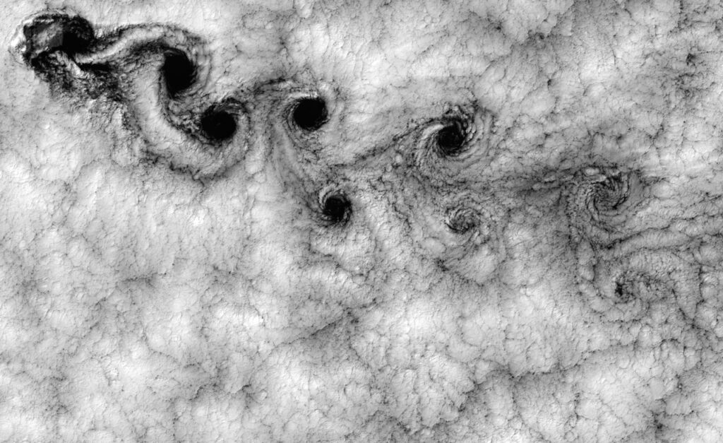 Black and white image of clouds from above showing a fractal pattern