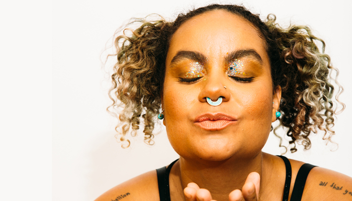 adrienne has a serene face, closed eyes with glitter on the lids