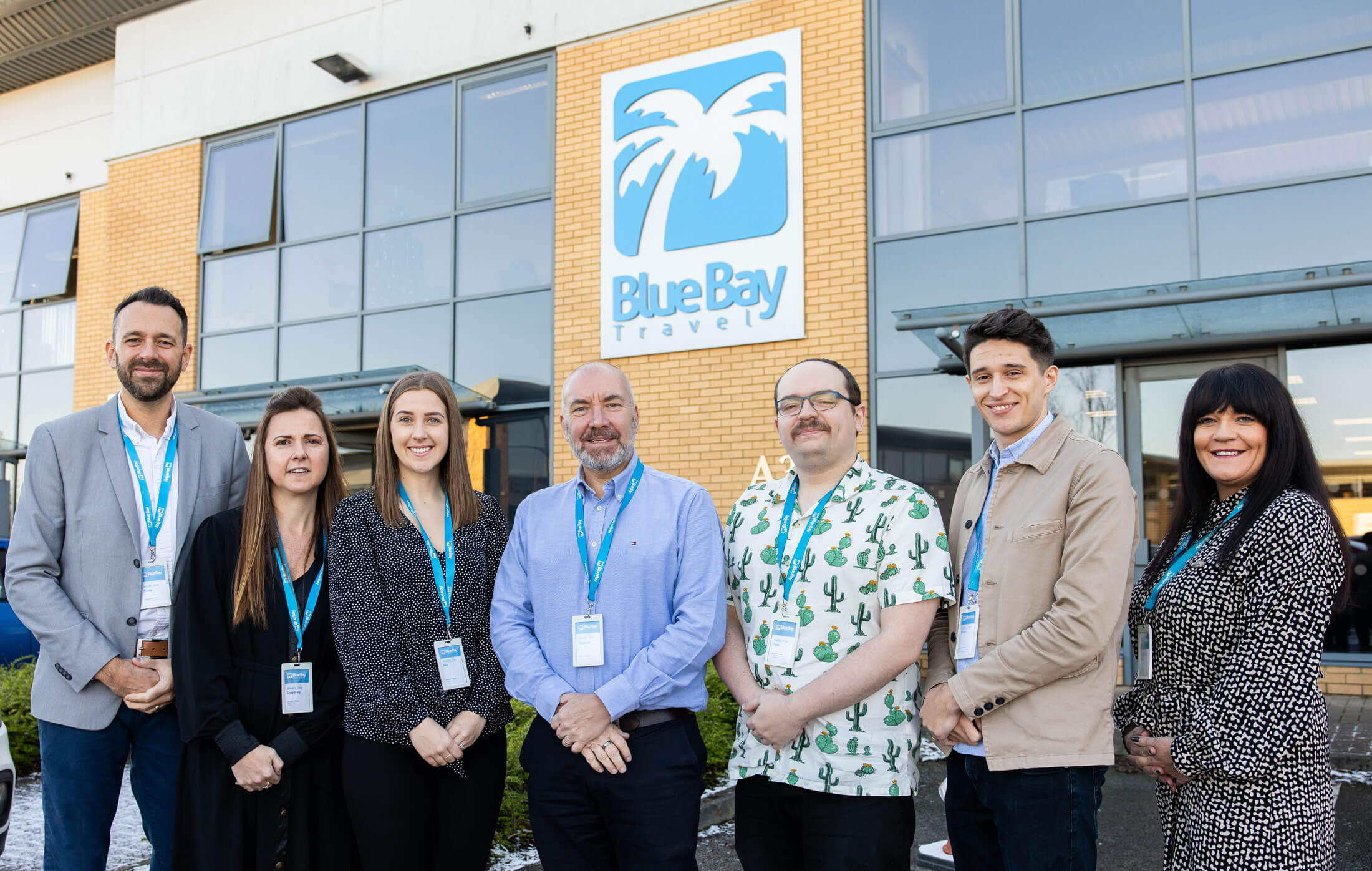 Blue Bay Travel's Senior Leadership team in front of the head office