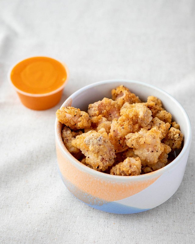 SPICED CALAMARI BITES ​​​​​​​​
seasoned popcorn bites of crispy calamari, served with a delicious Sr...