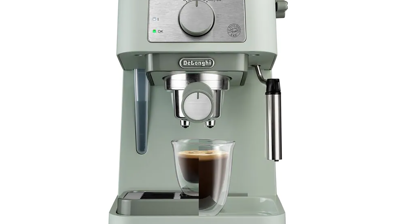 

                                        light green espresso machine with a glass of espresso coffee under the spout