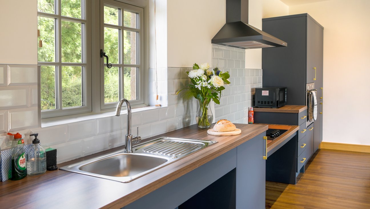 

                                        Kitchen area showing roll under sink, roll under hob and a window on the left hand side