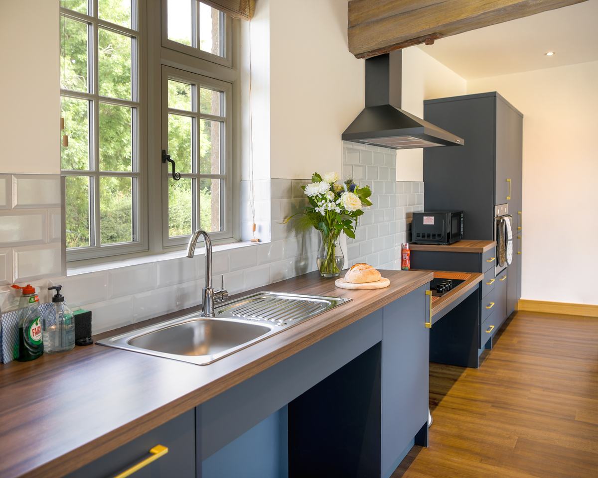 Kitchen area showing roll under sink, roll under hob and a window on the left hand side