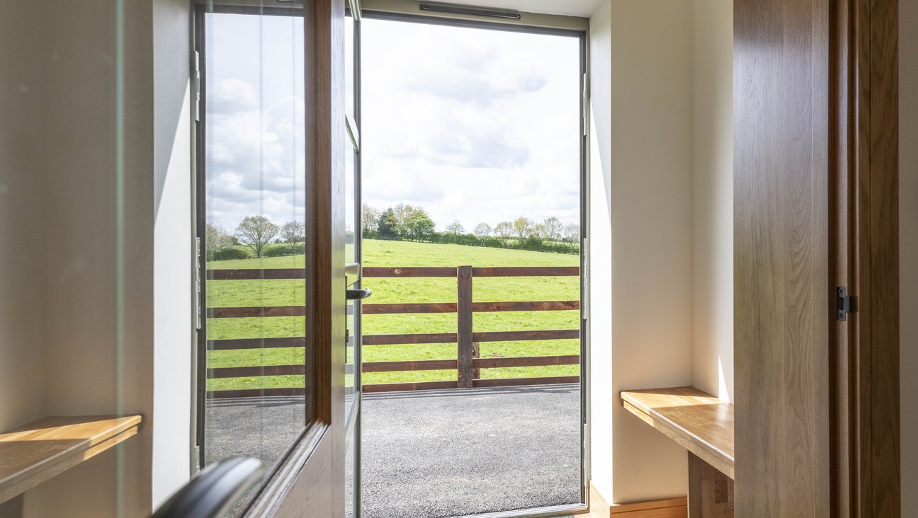 

                                        Porch with frosted glass door, bench to the right hand side and level access from driveway