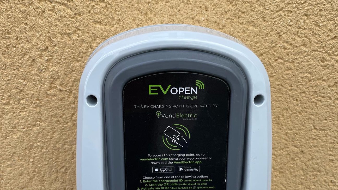 

                                        electric car charger on golden rendered wall