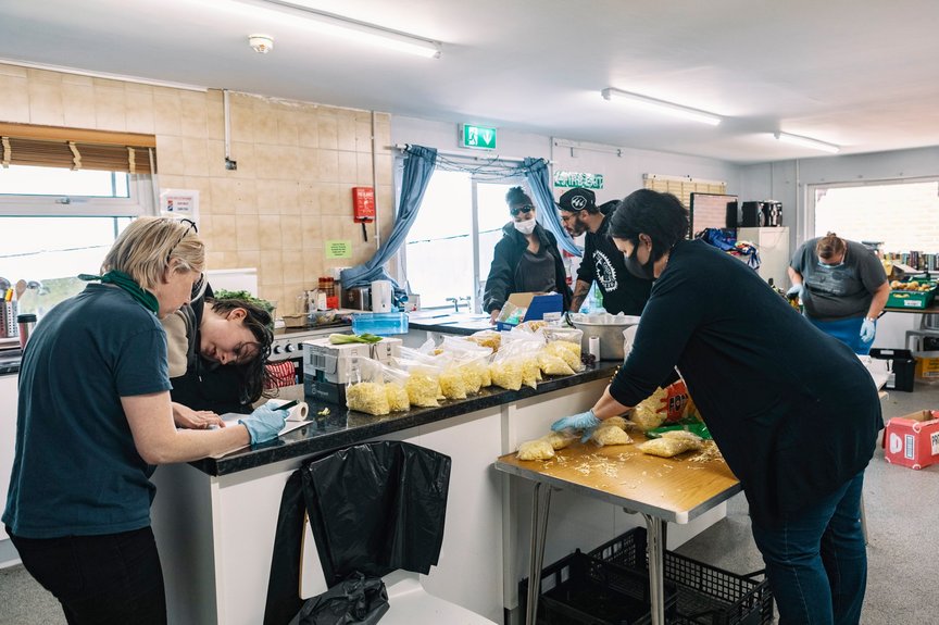Organisers sorting food in an industrial kitchen