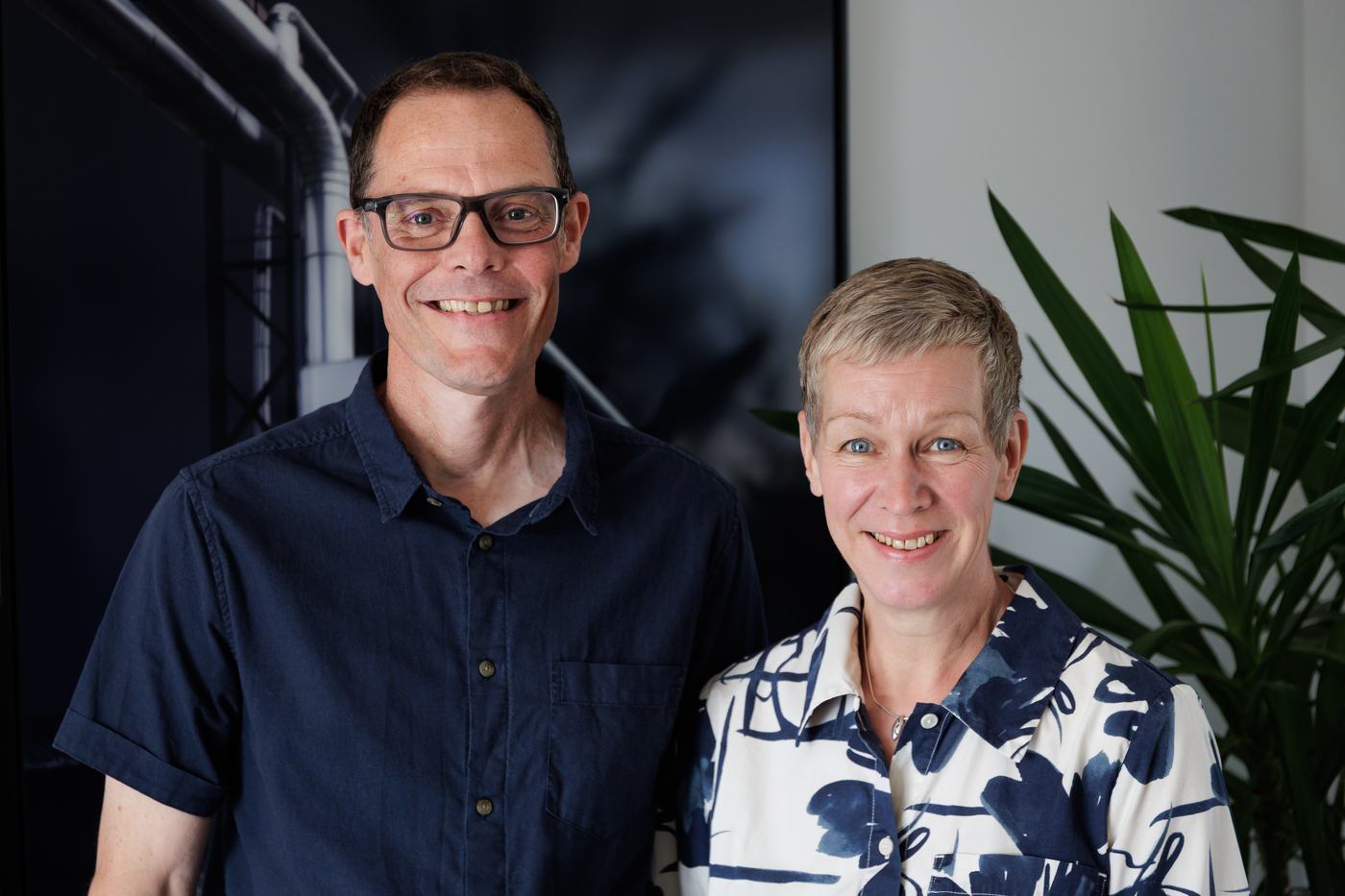 informal portrait of two people - a man and a woman - indoors