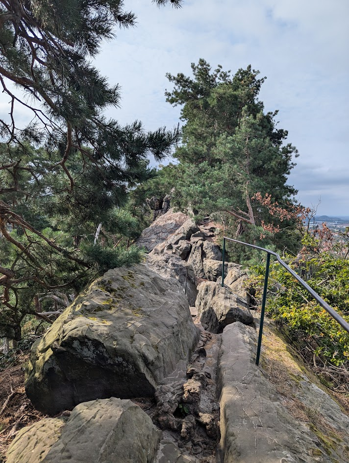 A stony footpath across a ridge, with steep drops towards both sides.