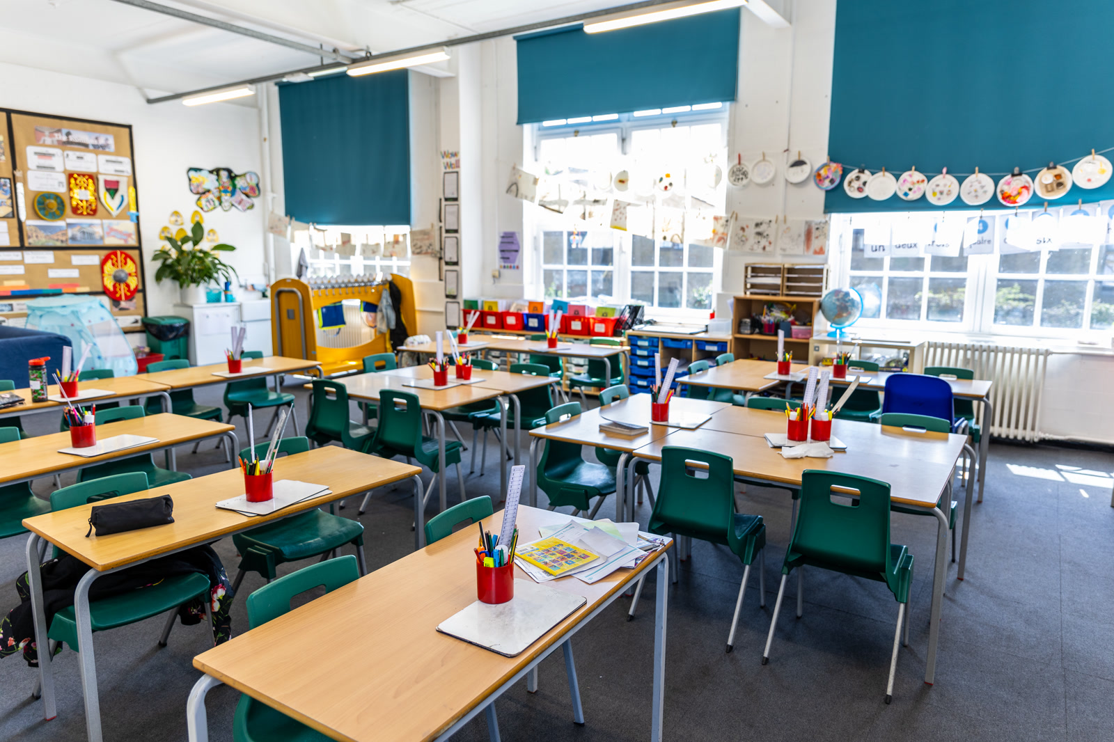 Empty classroom with colourful furniture and educational wall displays